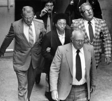 Black and white photograph of Wayne Williams being escorted back to jail