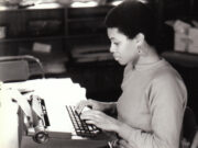 Black and white photo of Shay Youngblood at typewriter