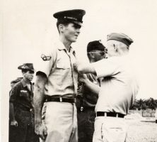 Black and white photograph of Leonard Matlovich receiving a Bronze Star in Vietnam.