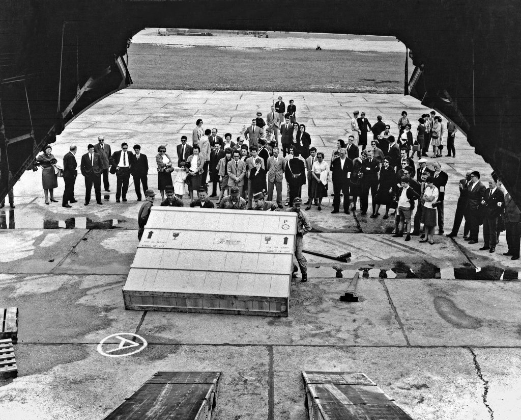 A group of people watch the unloading of a crate containing a painting by Jasper Johns at the XXXII Venice Biennale in Venice, Italy.