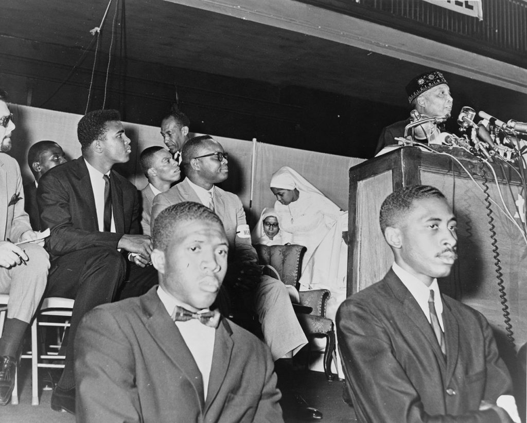 Elijah Muhammad addresses followers including Muhammad Ali.